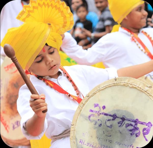 Girl in Yellow and White Dress Playing Drum